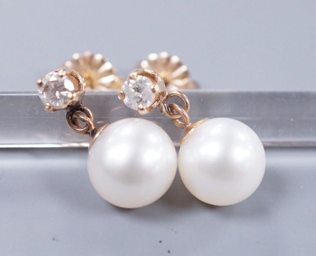 A pair of gold mounted diamond and cultured pearl drop earrings